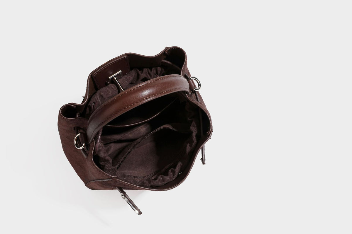Small structured bucket satchel in embossed velvet-texture fabric with silver turn-lock hardware, rounded top handle, and