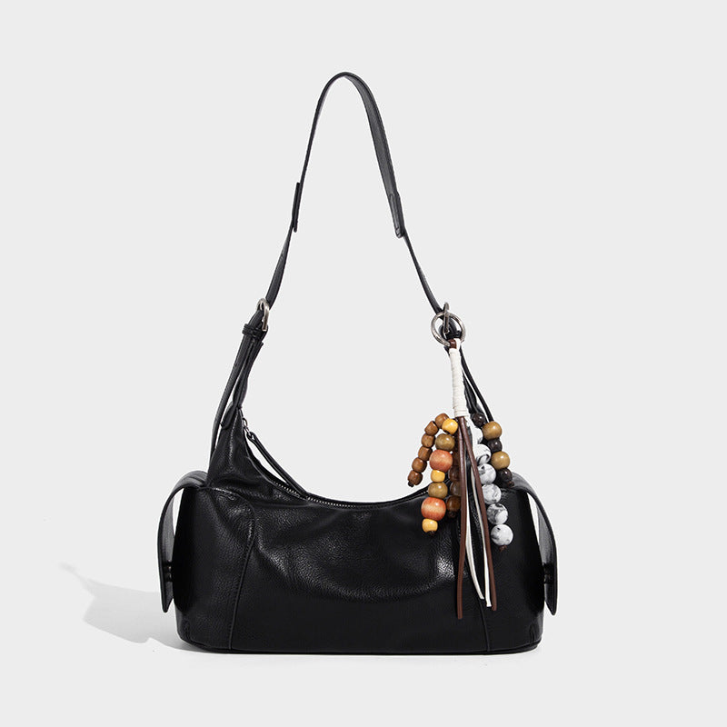Soft pebbled leather-look hobo shoulder bag with zip top closure, side flap pockets, and silver-tone hardware, front view