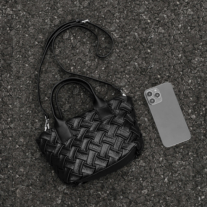 Small black glossy woven tote bag with dual top handles and detachable shoulder strap, detail view 4