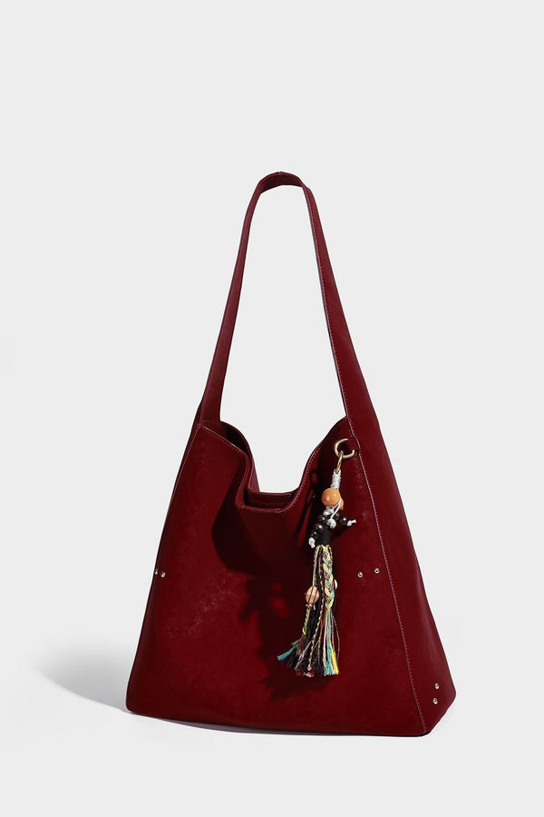 Oversized trapezoid tote bag with matte leather-look finish, gold-tone rivets, and long shoulder strap, detail view 15