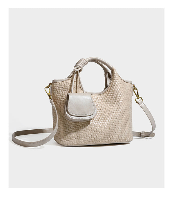 Woven leather-look tote bag in mocha brown with knotted top handle, front flap pocket, and detachable crossbody strap with