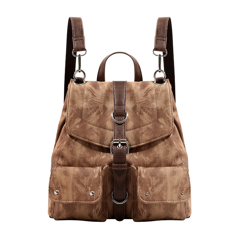 Compact distressed leather-look tan-brown backpack handbag with flap-and-buckle closure, two front patch pockets, top handle