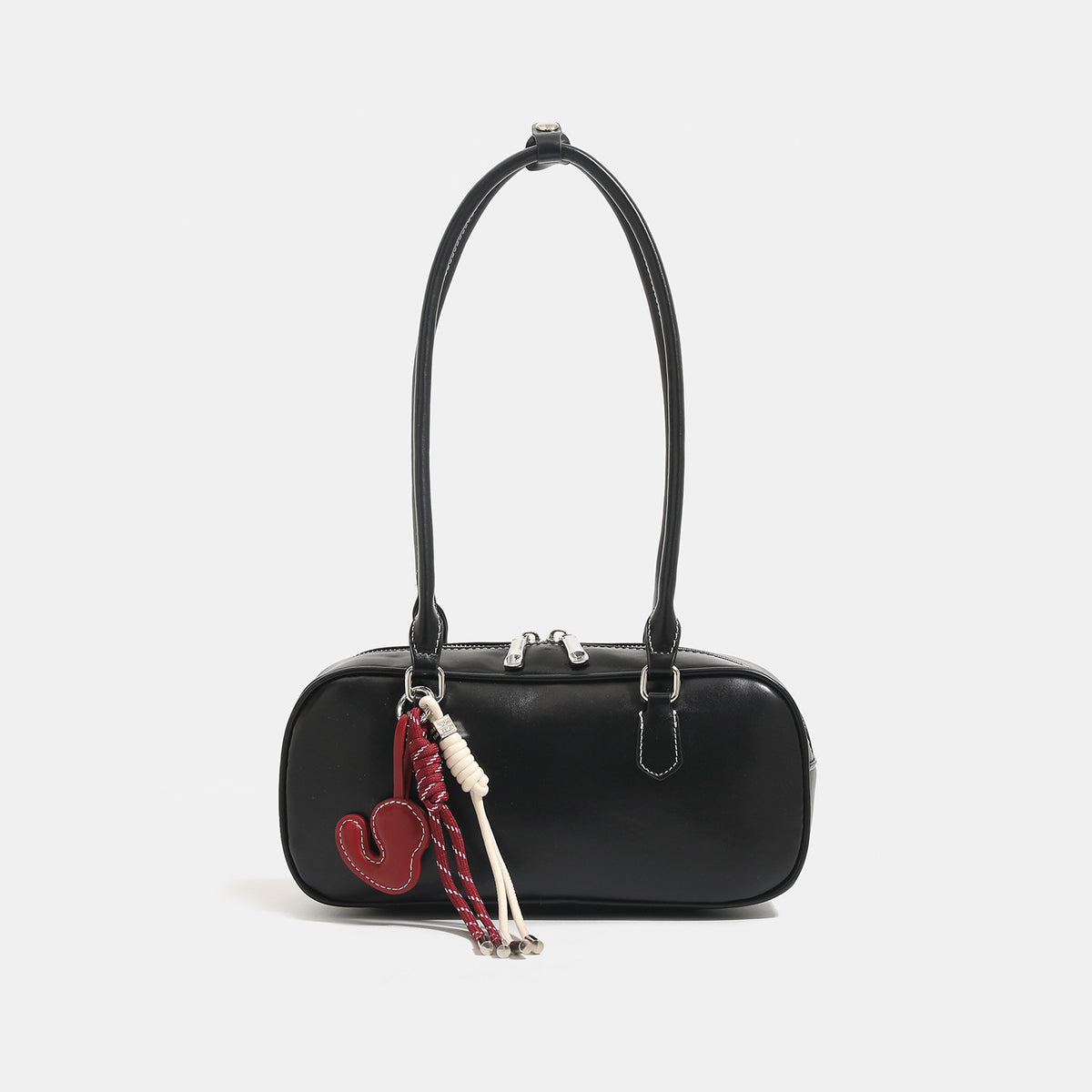 Compact rounded baguette shoulder bag with smooth leather-look finish, slim double straps, silver-tone zipper hardware, and
