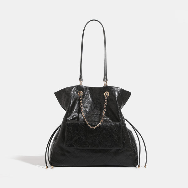 Quilted crinkled leather-look convertible tote backpack with gold-tone chain handles and drawstring closure, front view