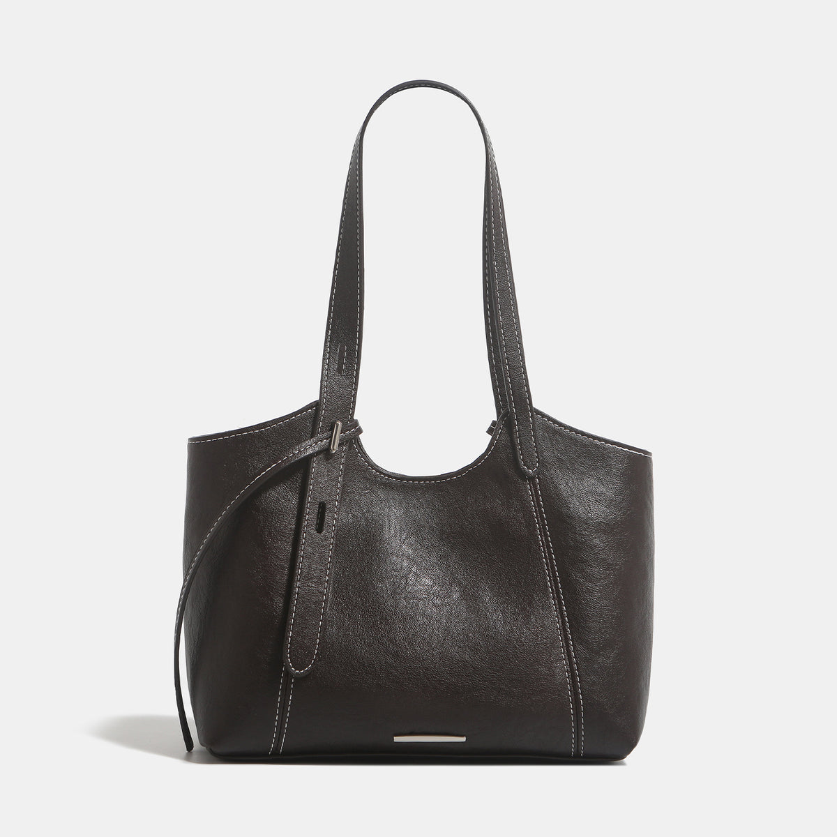 Structured leather-look tote shoulder bag with double crossed straps, contrast topstitching, and metal bar hardware, detail