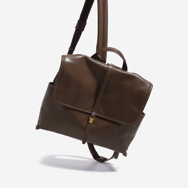 Structured retro flap backpack handbag in brown leather-look finish with gold-tone toggle clasp and top handle, detail view 2