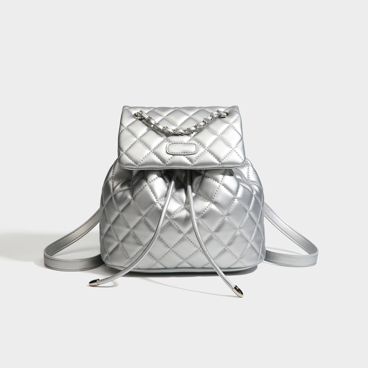 Black diamond-quilted backpack handbag with silver-tone chain flap accent and adjustable shoulder straps, detail view 8