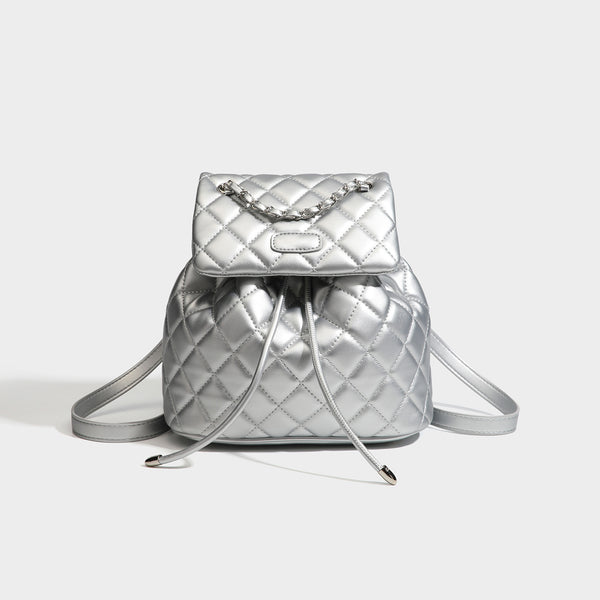 Black diamond-quilted backpack handbag with silver-tone chain flap accent and adjustable shoulder straps, detail view 8