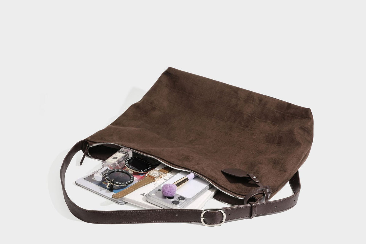 Slouchy hobo shoulder bag in matte croc-embossed leather-look finish with top zip closure and long adjustable strap, detail