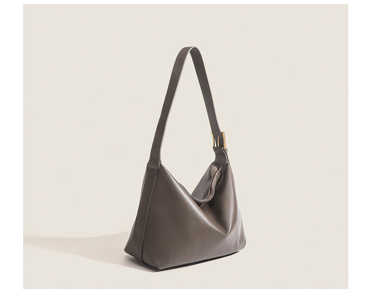 Large slouchy hobo shoulder bag in smooth leather-look finish with single long strap and gold-tone zip closure, detail view