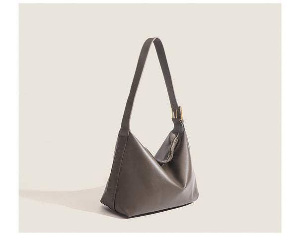 Large slouchy hobo shoulder bag in smooth leather-look finish with single long strap and gold-tone zip closure, detail view