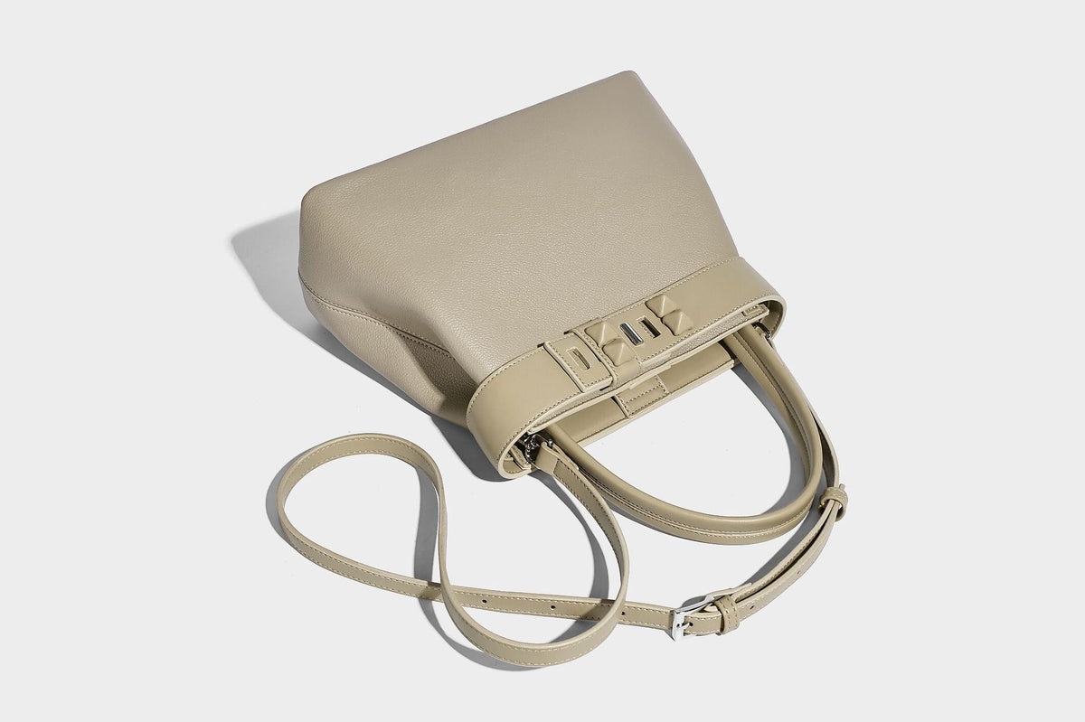Strukturierte trapezförmige Tote-Bag mit oberem Riemen mit Gürtelschnalle, genarbter Lederoptik und silberfarbenen Beschlägen, Detailansicht