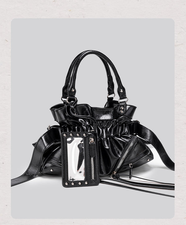 Black glossy ruched convertible tote bag with silver-tone rivets, detachable wide shoulder strap, external zip pouch, and