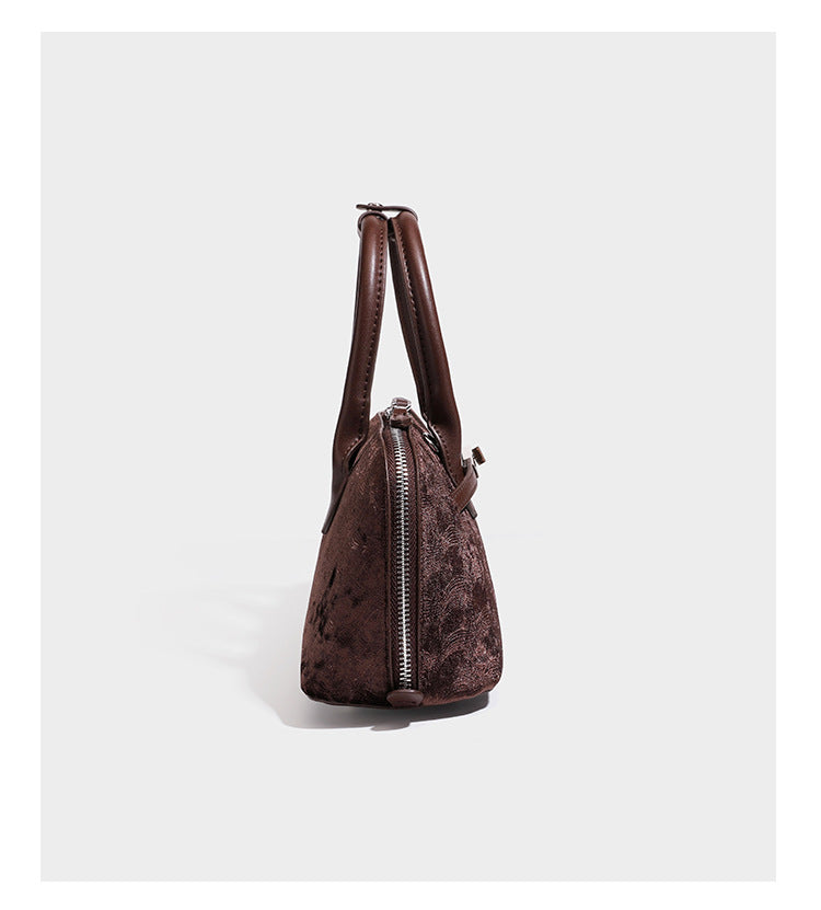 Small structured satchel bag in dark brown velvet-like textured finish with leather-look trim, silver-tone turn-lock bar