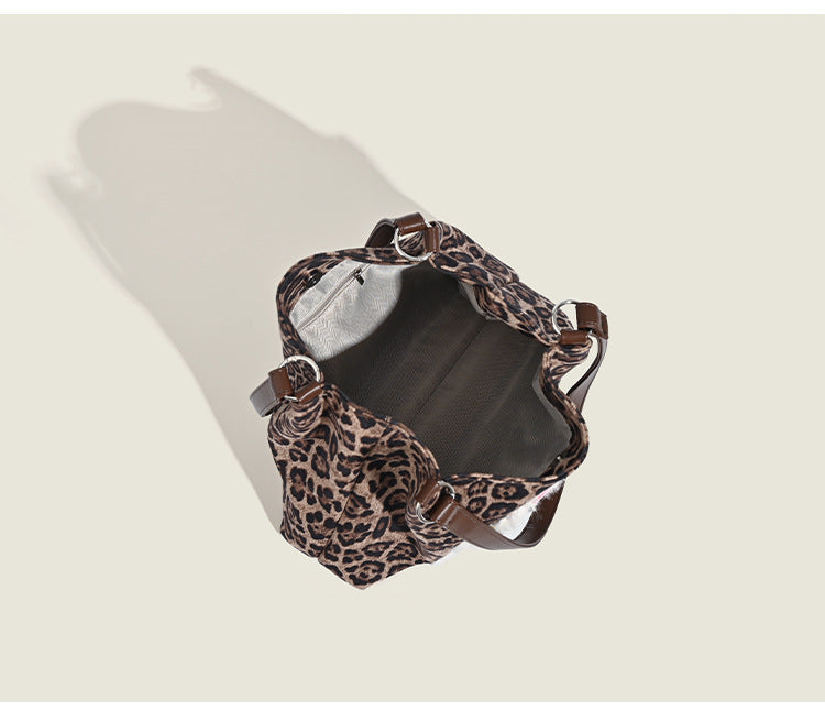 Leopard-print fabric tote bag with white plush teddy bear appliqué and brown leather-look shoulder straps, detail view 7