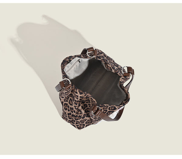 Leopard-print fabric tote bag with white plush teddy bear appliqué and brown leather-look shoulder straps, detail view 7
