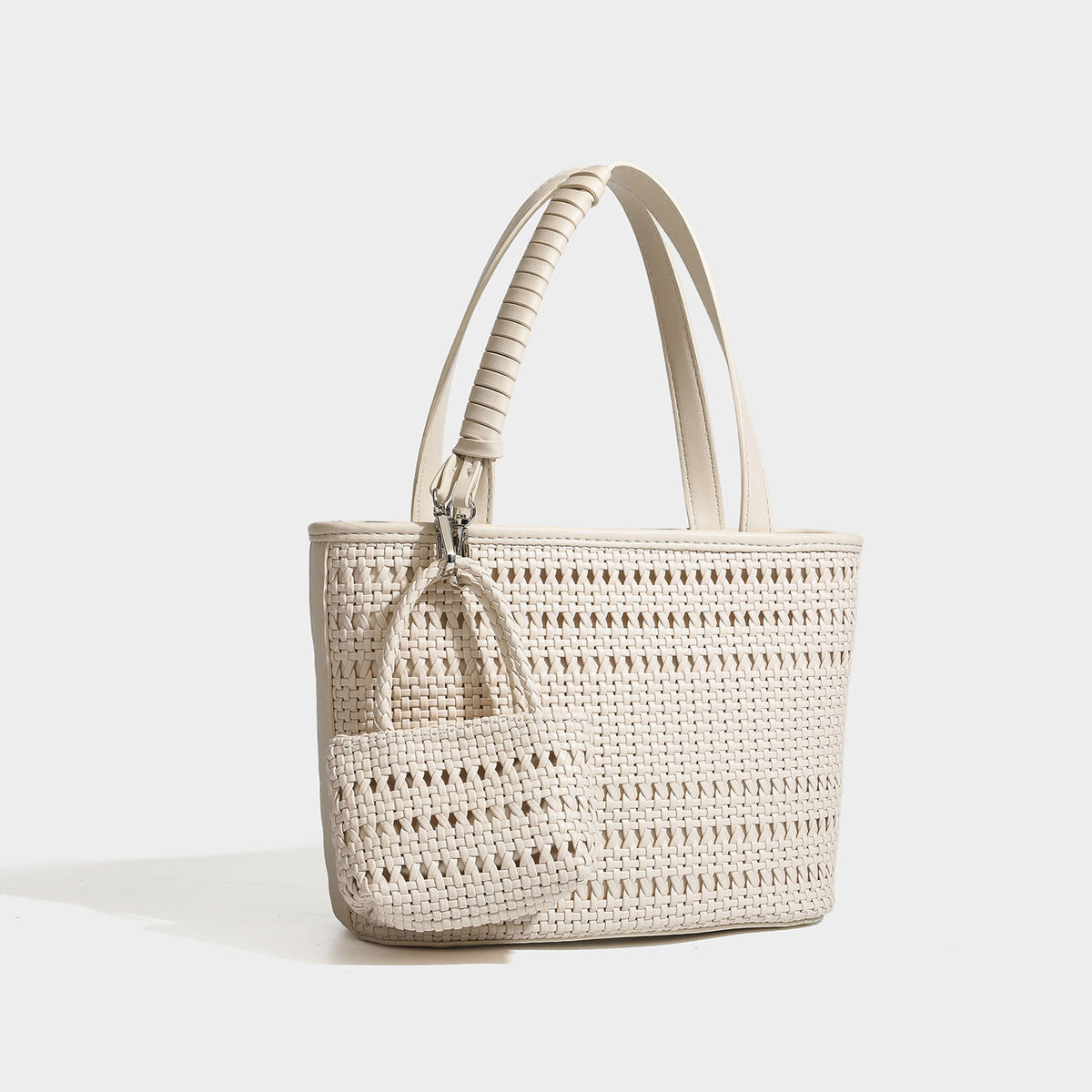 Structured open-weave tote bag with smooth leather-look trim, double top handles, detachable crossbody strap, and mini zip