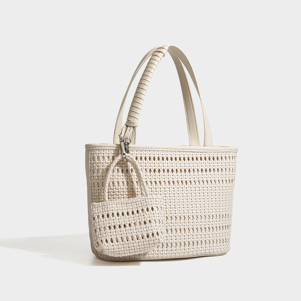 Structured open-weave tote bag with smooth leather-look trim, double top handles, detachable crossbody strap, and mini zip