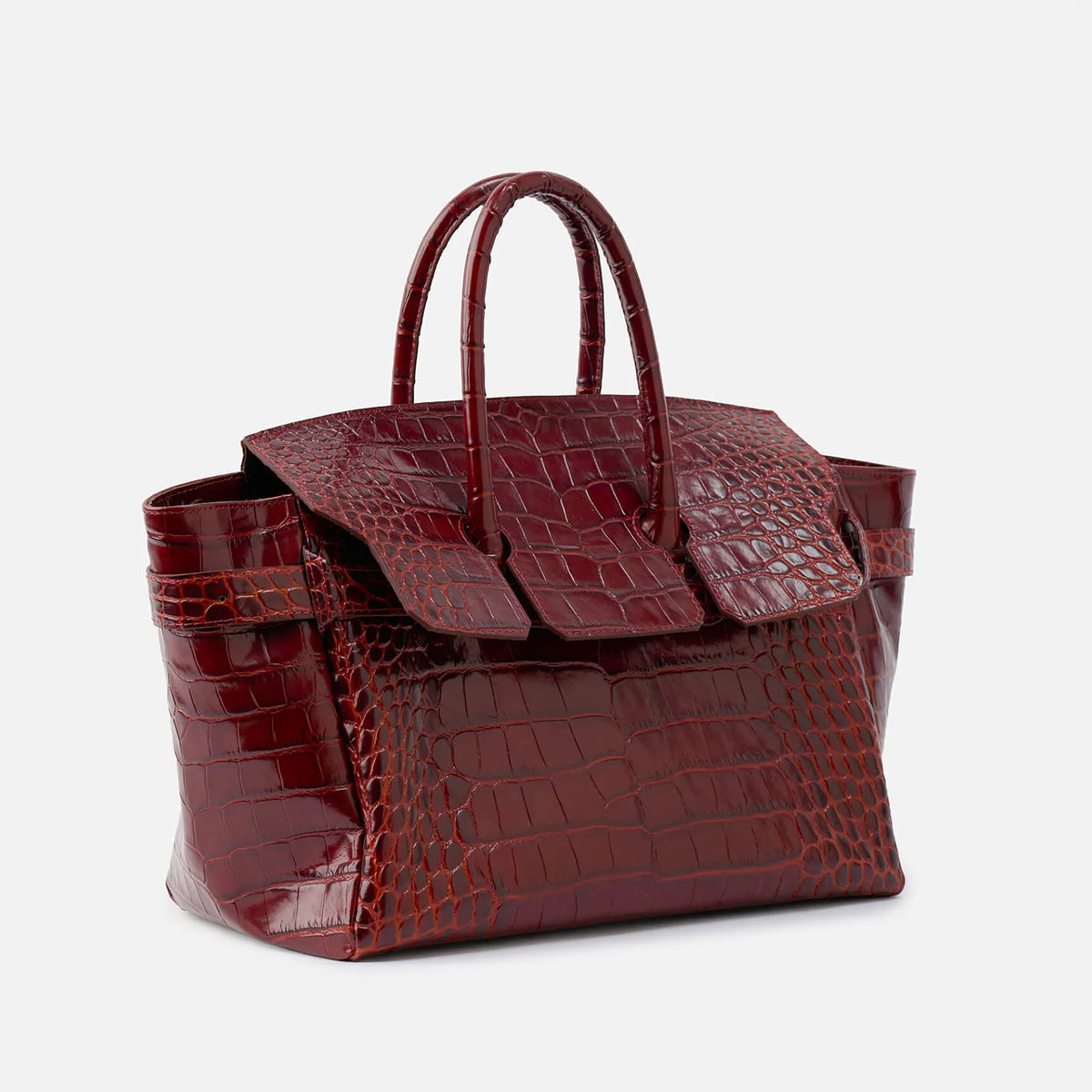 Large structured tote satchel with glossy crocodile-embossed leather-look finish, dual top handles, and metal buckle flap