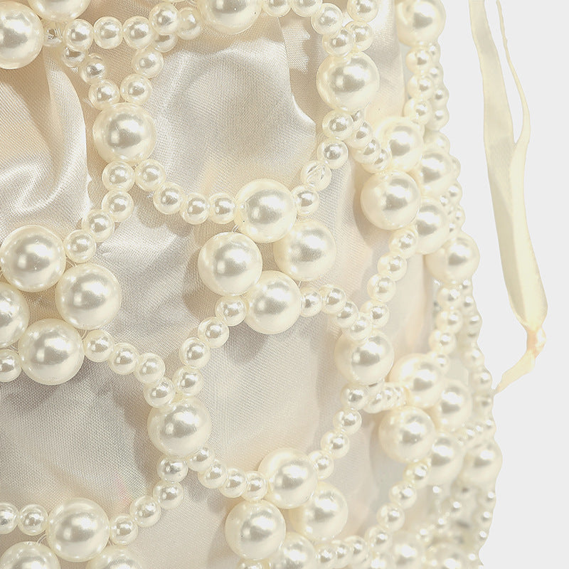 Small pearl-beaded lattice drawstring bucket bag with beaded shoulder strap and ribbon closure, detail view 21