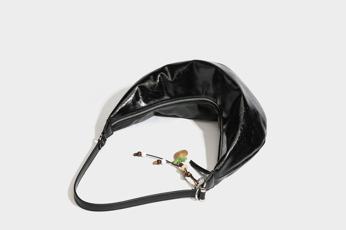 Lässig fallende Hobo-Schultertasche in Halbmondform mit glänzender, geknautschter Lederoptik, schmalem Riemen, silberfarbenen Ringbeschlägen und