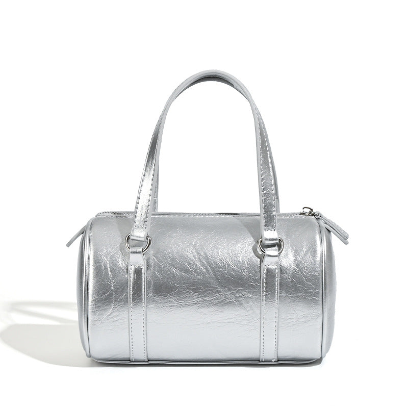 Mini silver barrel bag with crinkled leather-look finish, top handles, and silver-tone hardware, detail view 5
