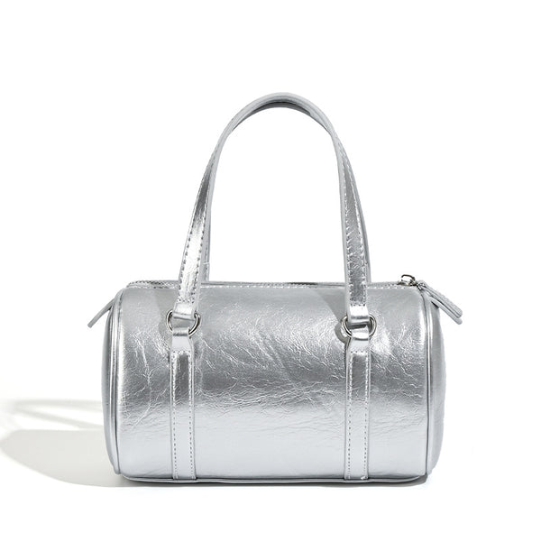 Mini silver barrel bag with crinkled leather-look finish, top handles, and silver-tone hardware, detail view 5