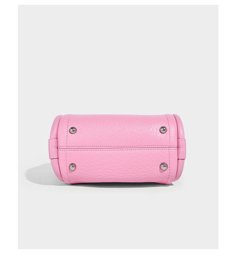 Structured mini tote bag in pebbled leather-look finish with knotted top handles, front flap pocket, and detachable shoulder