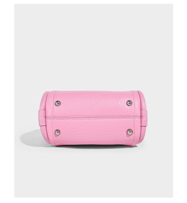 Structured mini tote bag in pebbled leather-look finish with knotted top handles, front flap pocket, and detachable shoulder