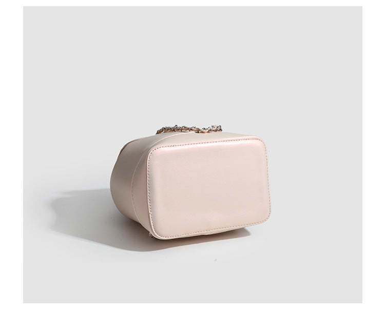 Small pearl-gloss backpack handbag with woven silver chain straps and turn-lock flap closure, detail view 11