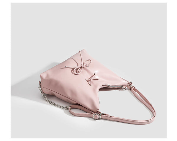 Glossy leather-look hobo shoulder bag with front bow lacing detail and silver-tone chain strap, detail view 16