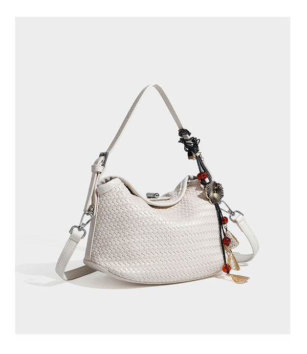 Small woven-look leather-look flap shoulder hobo bag in burgundy with silver-tone hardware and decorative tassel charm