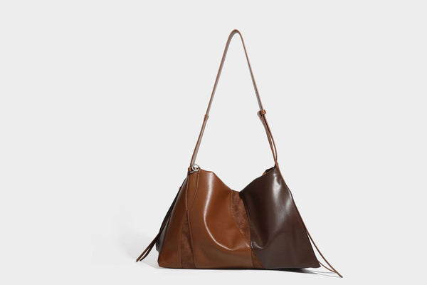 Two-tone black and brown leather-look slouchy shoulder bag with beaded tassel charm and silver-tone hardware, detail view 21