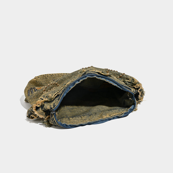 Large distressed denim hobo shoulder bag with mixed-metal rivet detailing and tan leather-look corner trim, detail view 4