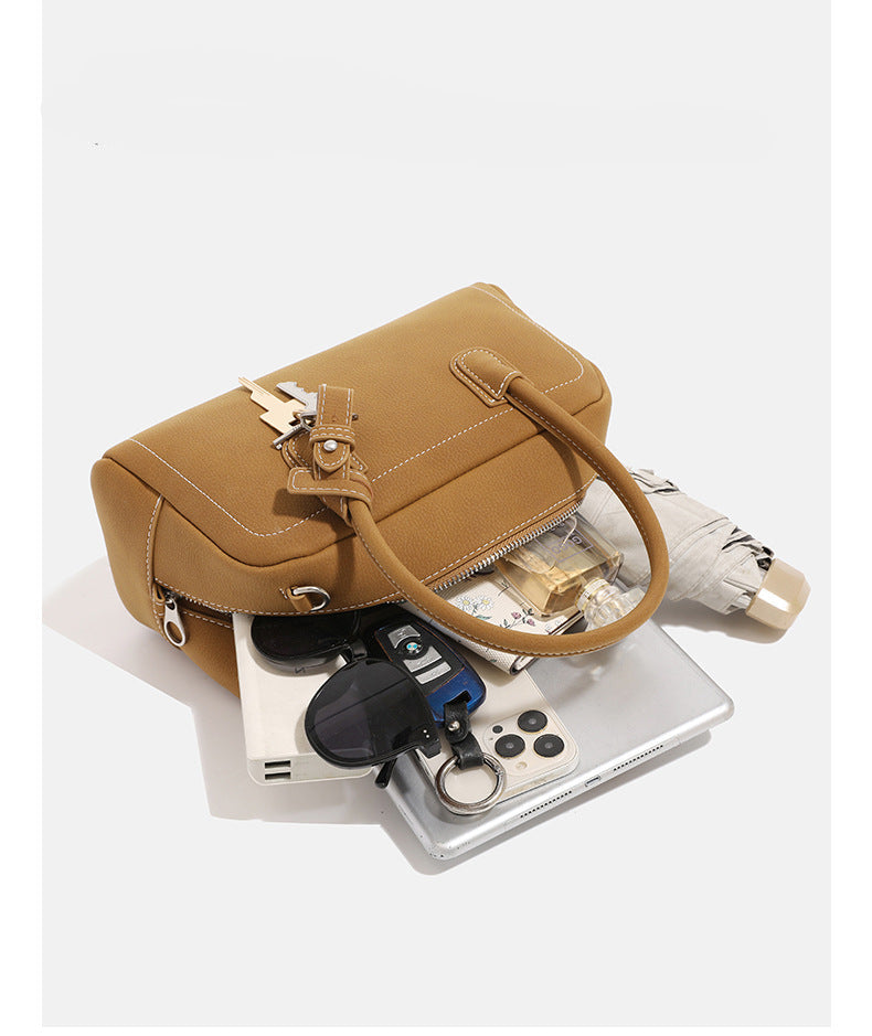 Compact retro Boston satchel bag with matte suede-look finish, twin rounded top handles, double zip closure with silver-tone
