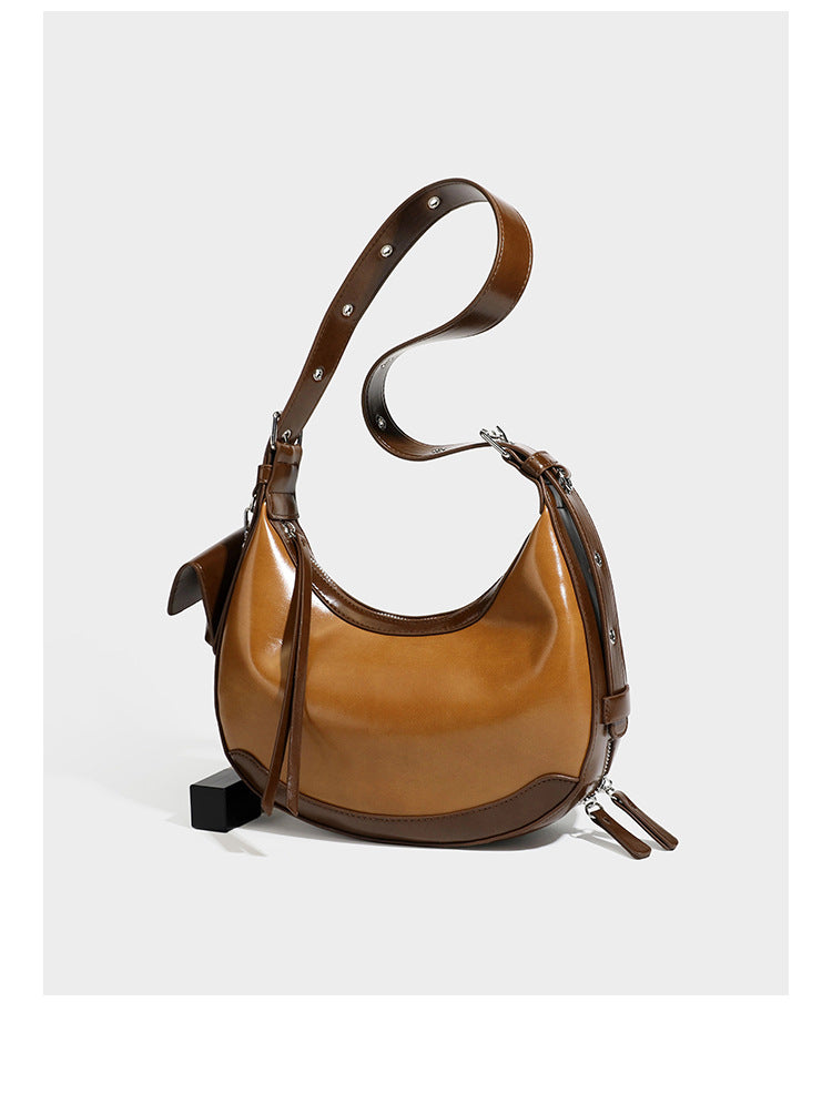 Glossy leather-look crescent hobo shoulder bag with dark contrast trim, silver-tone hardware, and attached mini flap pouch