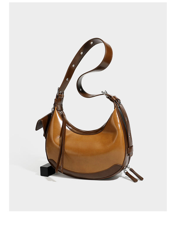 Glossy leather-look crescent hobo shoulder bag with dark contrast trim, silver-tone hardware, and attached mini flap pouch
