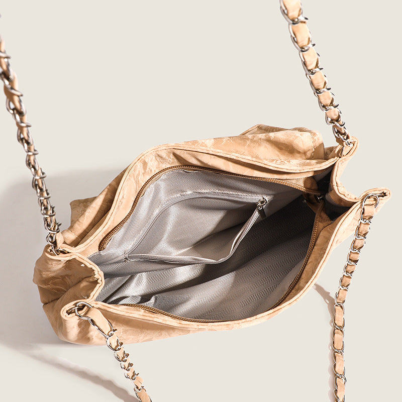 Crinkle-finish leather-look shoulder bag with woven tan-and-metal chain strap and front flap turn-lock closure, detail view 4