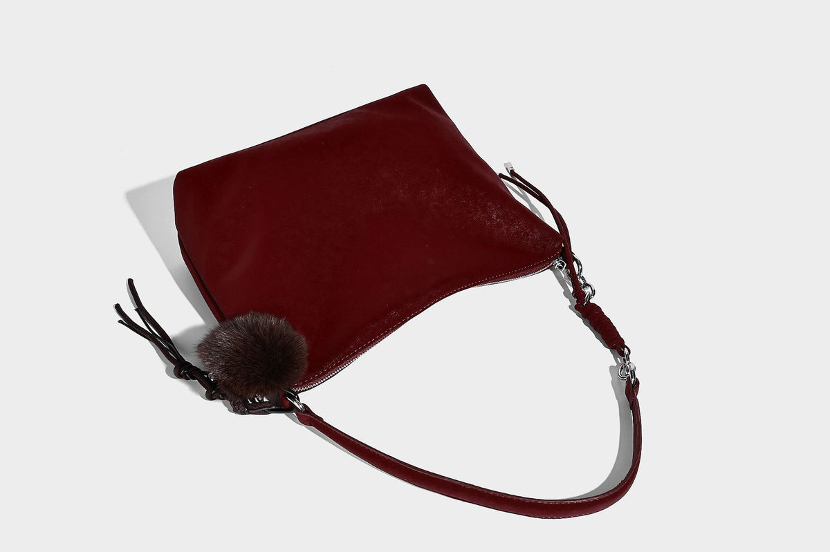 Slouchy matte-finish hobo shoulder bag with tassel cords, silver-tone hardware, and faux-fur pom charm, detail view 30