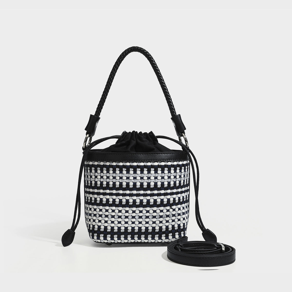 Small structured woven checker bucket bag with braided top handle, drawstring closure, and silver-tone hardware in black