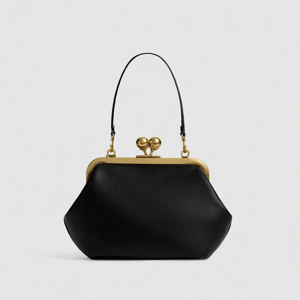 Oversized kiss-lock frame handbag with gold-tone metal clasp and smooth leather-look finish, detail view 12