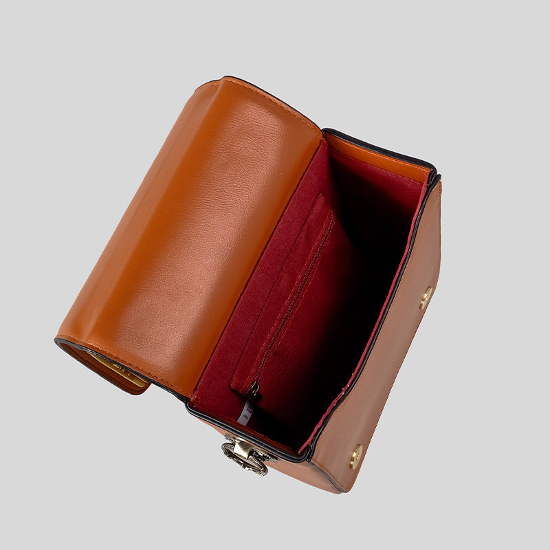 Small structured rectangular crossbody bag with ornate antique-style clock face and brass hardware in, detail view 3