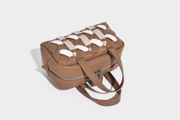 Small structured satchel bag with two-tone woven front panel, dual top handles, and detachable crossbody strap in tan brown