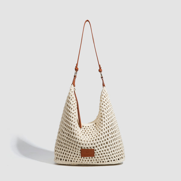Cream open-weave crochet hobo shoulder bag with tan leather-look strap and gold-tone ring hardware, front view