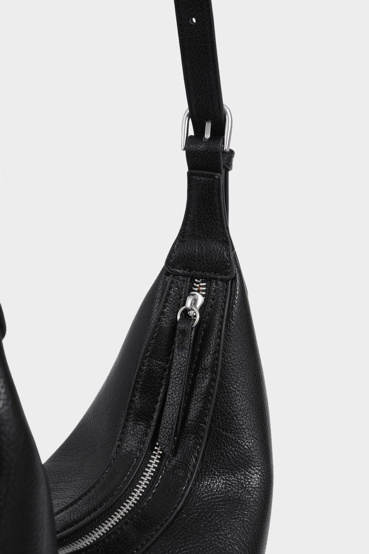 Crescent half-moon shoulder bag in pebbled leather-look finish with adjustable strap and silver-tone hardware, detail view 24