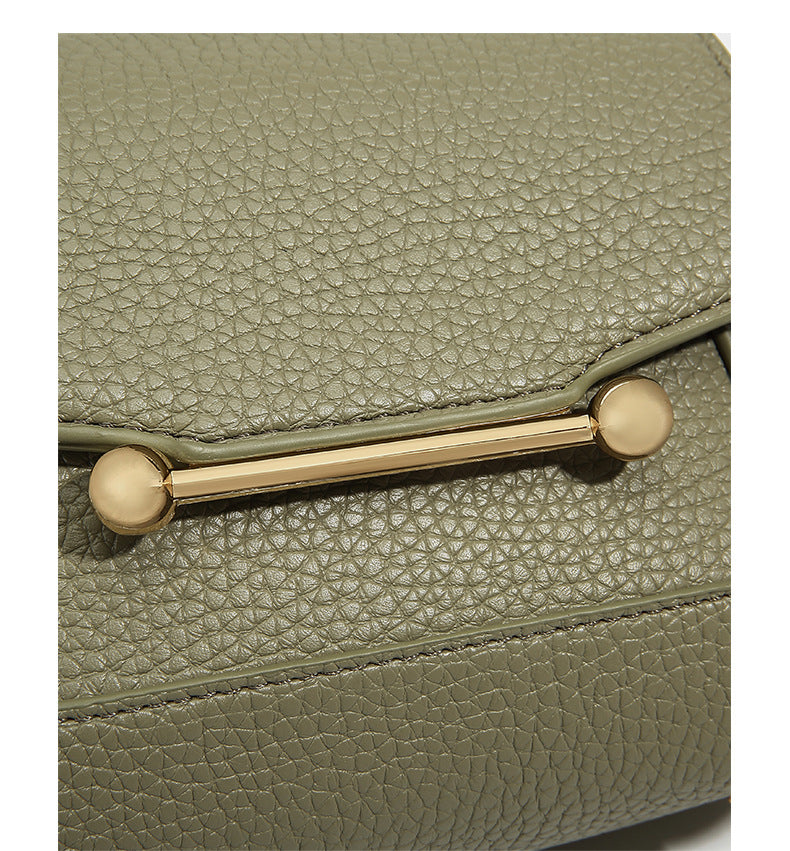 Small structured pebbled flap mini satchel with gold-tone bar hardware, short top handle, and detachable crossbody strap