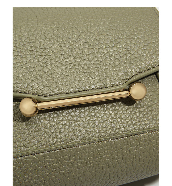 Small structured pebbled flap mini satchel with gold-tone bar hardware, short top handle, and detachable crossbody strap