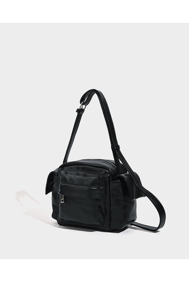 Boxy leather-look crossbody bag with front zip pockets, top zip closure, and long adjustable strap, detail view 10