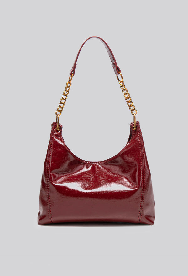 Glossy leather-look hobo shoulder bag with gold-tone chain-and-leather strap in deep burgundy red, detail view 11