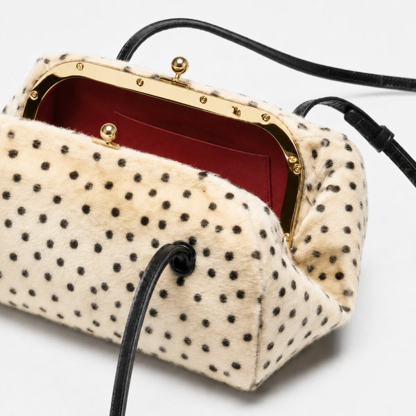 Spotted faux-fur barrel shoulder bag with gold kiss-lock clasp and black adjustable leather-look straps, detail view 4